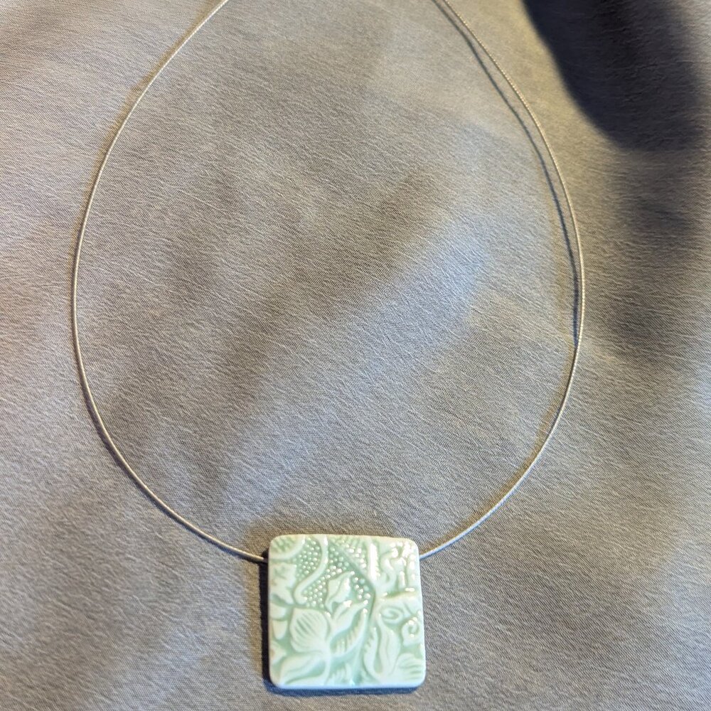 Artisan wire collar necklace with embossed square ceramic botanical pendant